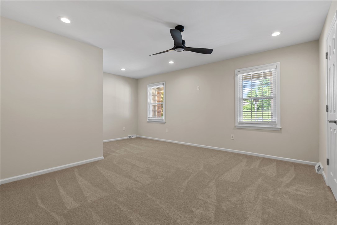 3513 Hopewell Road Anderson, SC 29621 - Photo 14 of 50 Well-lit sleeping quarters with plush carpeting and modern ceiling fan create a serene atmosphere.