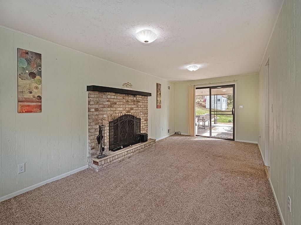 1749 Washington Road Apollo, PA 15613 - Photo 16 of 36 an empty room with windows and fireplace
