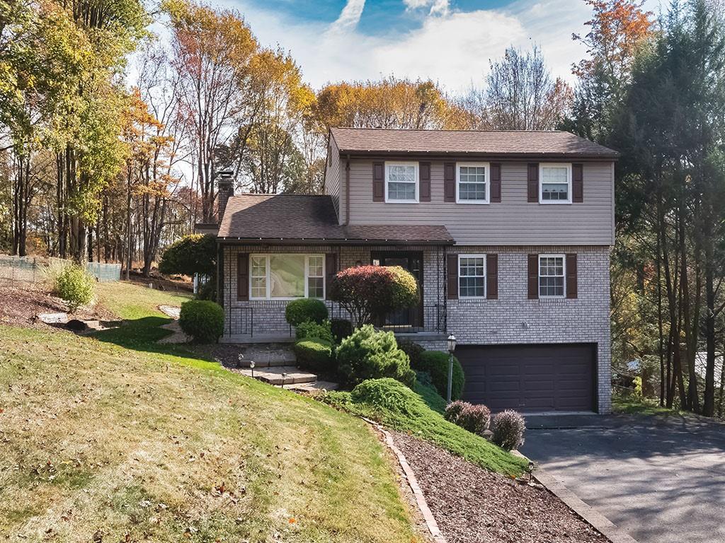 1749 Washington Road Apollo, PA 15613 - Photo 2 of 36 a front view of a house with a yard and garage