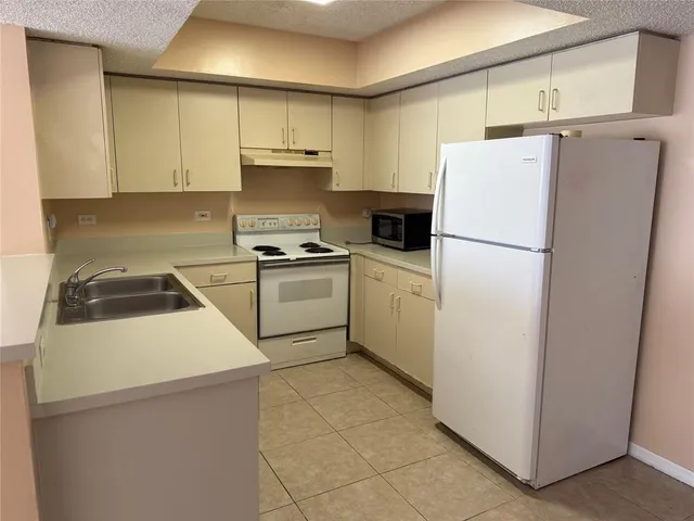 a white refrigerator freezer sitting in a kitchen