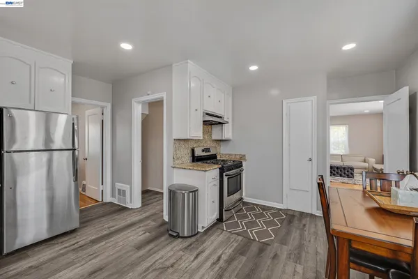 a kitchen with stainless steel appliances granite countertop a refrigerator stove microwave and sink