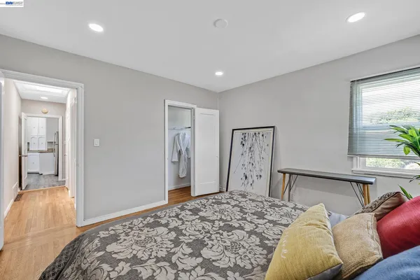 a bedroom with a bed and wooden floor