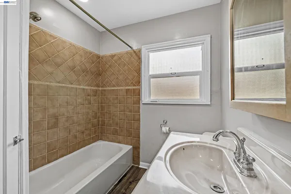 a bathroom with a granite countertop bathtub and a sink