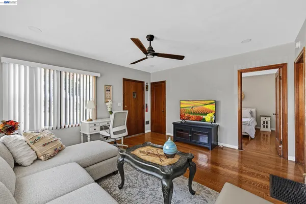 a living room with furniture and wooden floor