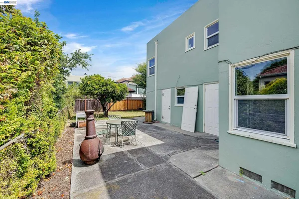 a view of a patio with table and chairs and potted plants