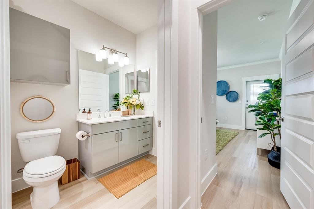 579 Lloyd's Road, Unit 1213A Little Elm, TX 75068 - Photo 13 of 34 a bathroom with a sink a toilet and a mirror