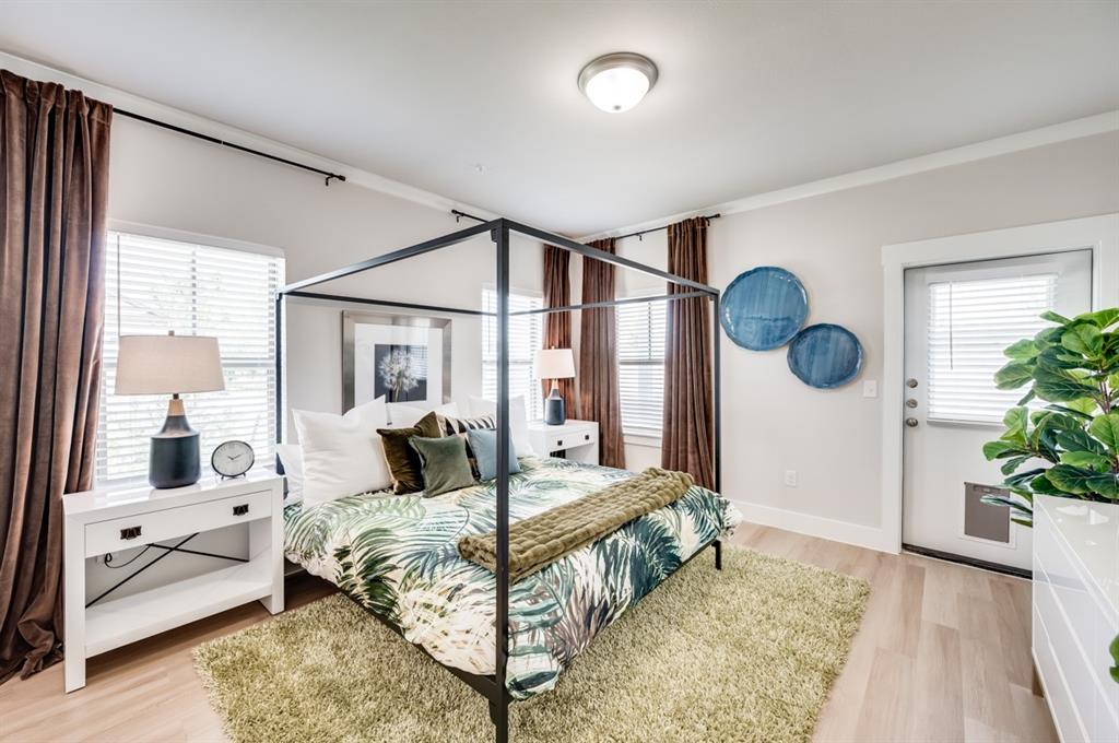 579 Lloyd's Road, Unit 1213A Little Elm, TX 75068 - Photo 14 of 34 a bedroom with a large bed and a chandelier