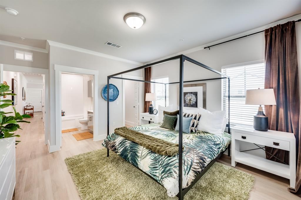 579 Lloyd's Road, Unit 1213A Little Elm, TX 75068 - Photo 15 of 34 a bedroom with a large bed and a chandelier