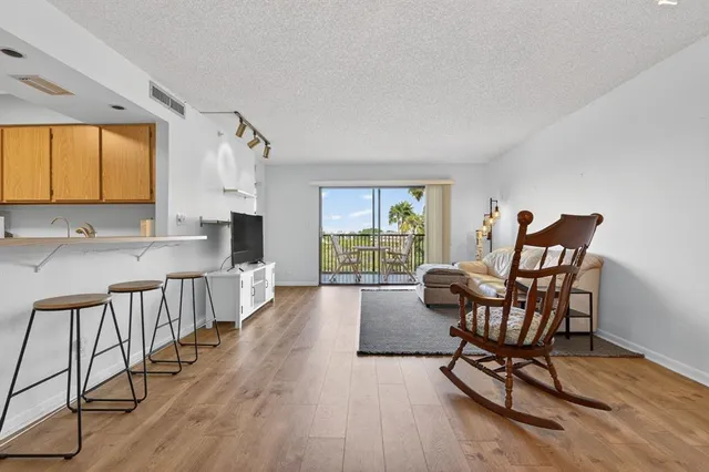 a living room with furniture a wooden floor and a window