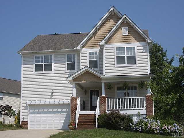 131 Locke Woods Road Raleigh, NC 27603 - Photo 1 of 18 a front view of a house with a garden