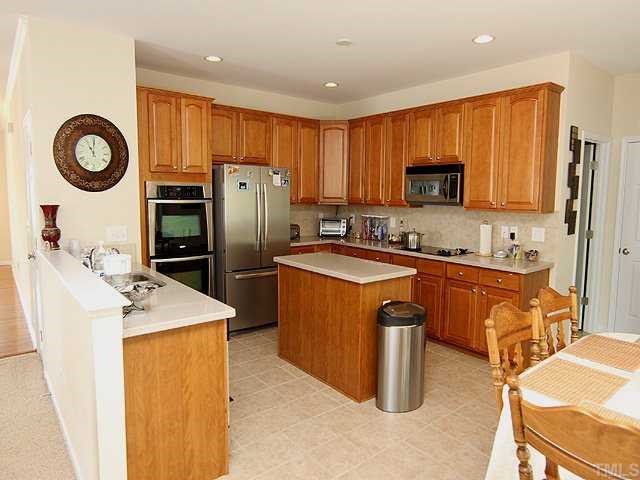 131 Locke Woods Road Raleigh, NC 27603 - Photo 14 of 18 a kitchen with stainless steel appliances granite countertop a refrigerator stove top oven a sink and dishwasher