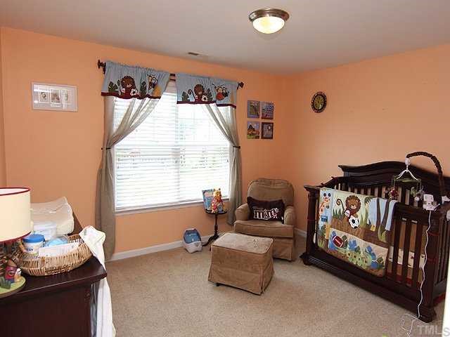 131 Locke Woods Road Raleigh, NC 27603 - Photo 17 of 18 a bedroom with furniture and a window