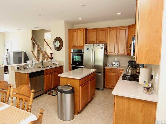 131 Locke Woods Road Raleigh, NC 27603 - Photo 4 of 18 a kitchen with a sink stove and refrigerator