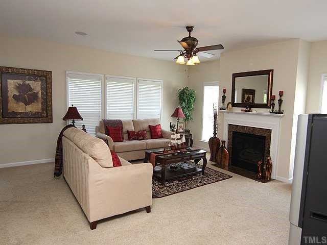 131 Locke Woods Road Raleigh, NC 27603 - Photo 6 of 18 a living room with furniture a window and a fireplace
