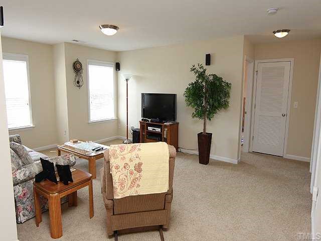 131 Locke Woods Road Raleigh, NC 27603 - Photo 9 of 18 a living room with furniture and a flat screen tv