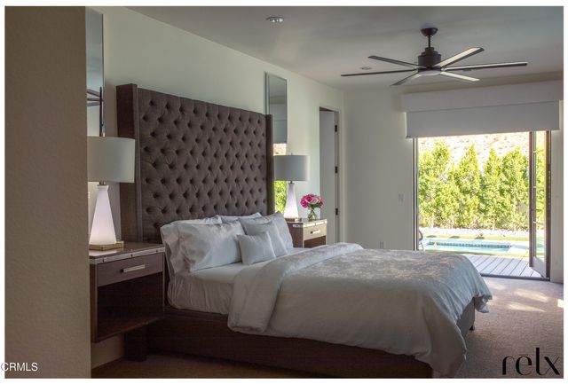 a living room with furniture a fireplace and a chandelier