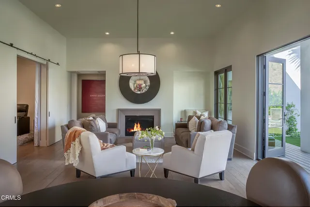 a view of a house with swimming pool and sitting area