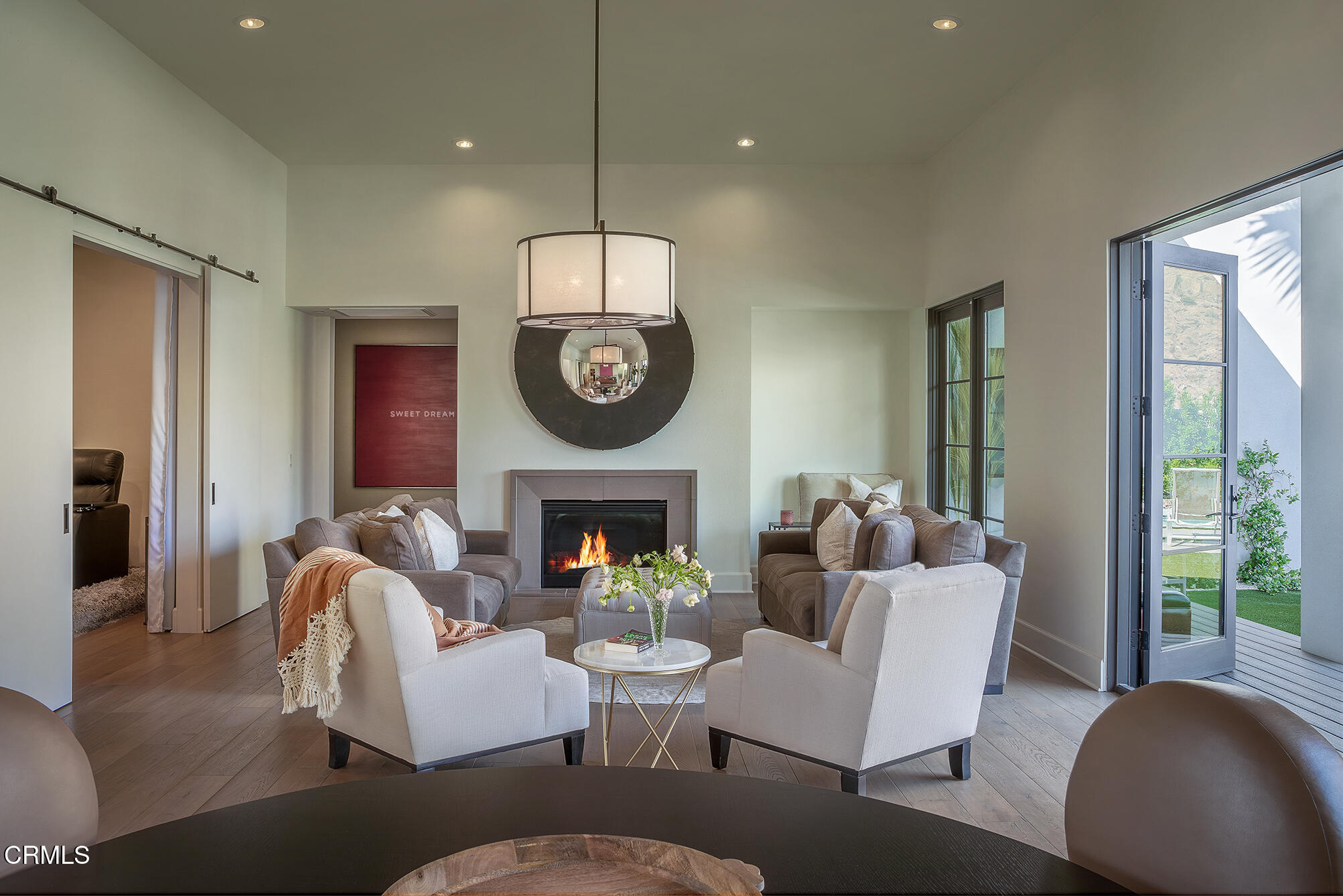 3076 Arroyo Seco Palm Springs, CA 92264 - Photo 13 of 37 a living room with furniture a fireplace and a chandelier