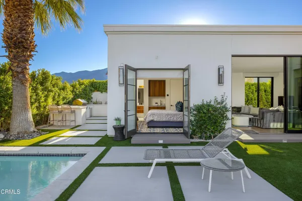 a view of a patio with table and chairs potted plants with wooden floor