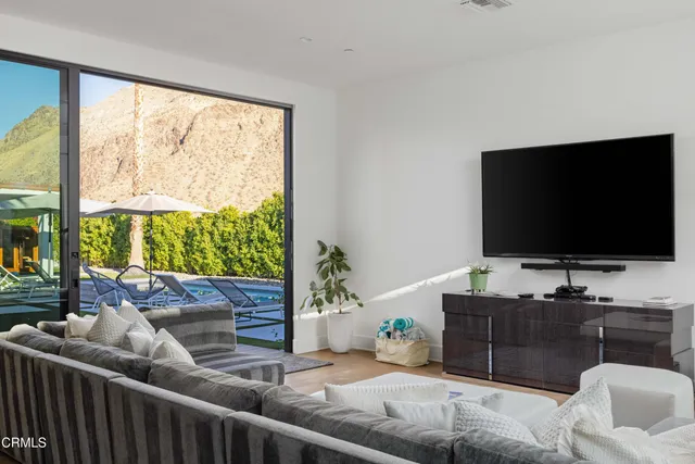 a living room with furniture and large windows