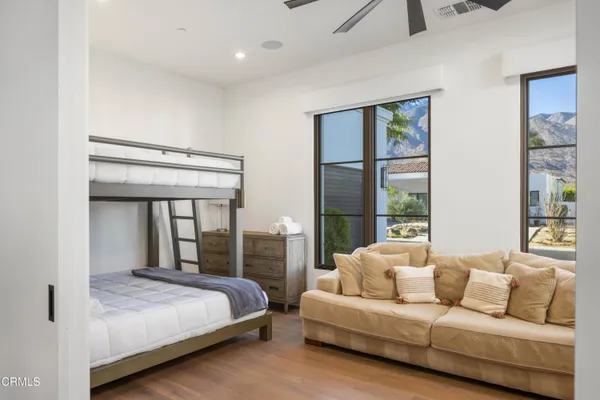 a bedroom with a large bed and a balcony view
