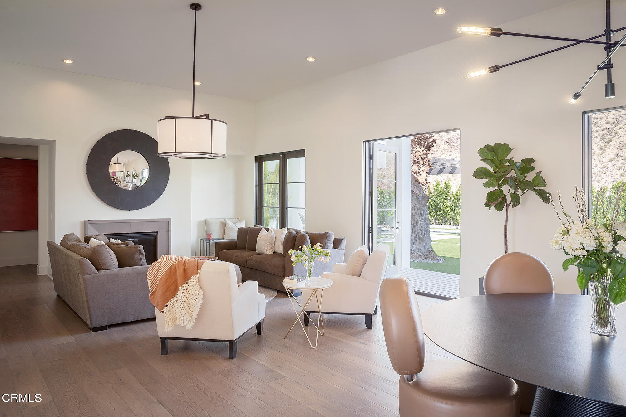 3076 Arroyo Seco Palm Springs, CA 92264 - Photo 3 of 37 a living room with couches a coffee table and a chandelier