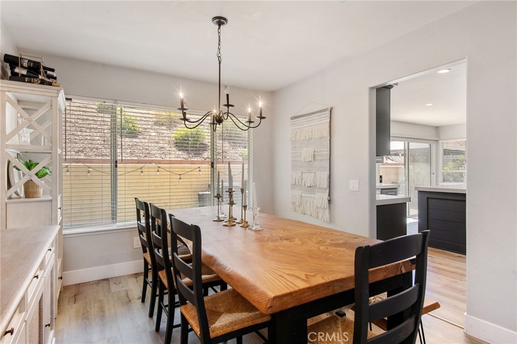 40456 Windsor Road Temecula, CA 92591 - Photo 5 of 38 a view of a dining room and livingroom with furniture window and wooden floor