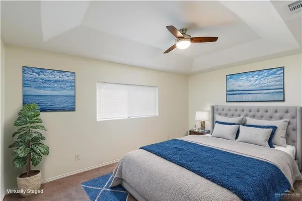 a bedroom with a bed and a potted plant