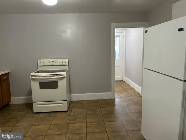 a white stove top oven sitting inside of a kitchen