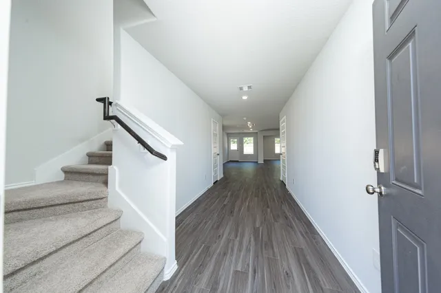 a view of entryway and hall with wooden floor