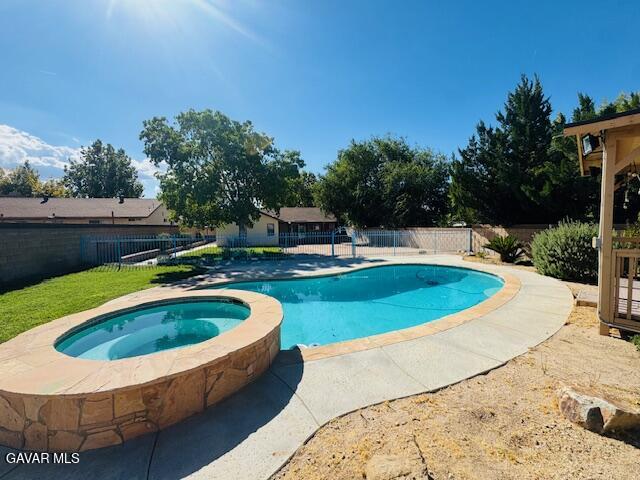 42636 Roadrunner Way Lancaster, CA 93536 - Photo 3 of 19 a view of a swimming pool with an outdoor space and seating area