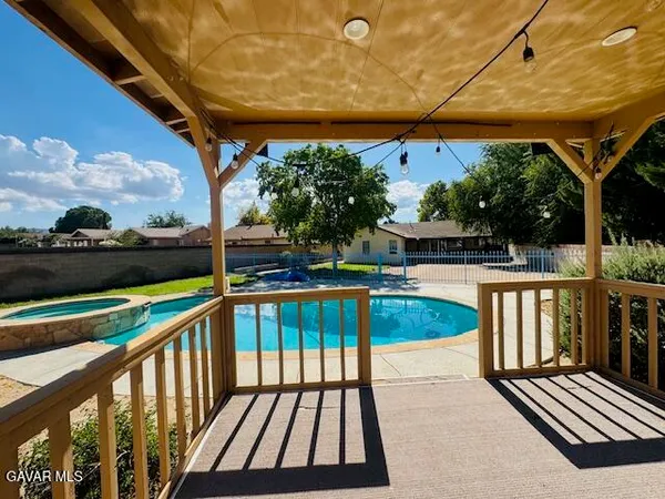 a view of balcony with wooden floor and outdoor seating
