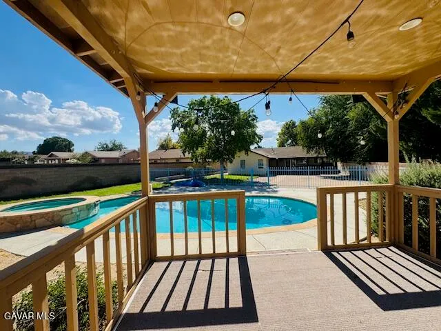 a view of balcony with wooden floor and outdoor seating