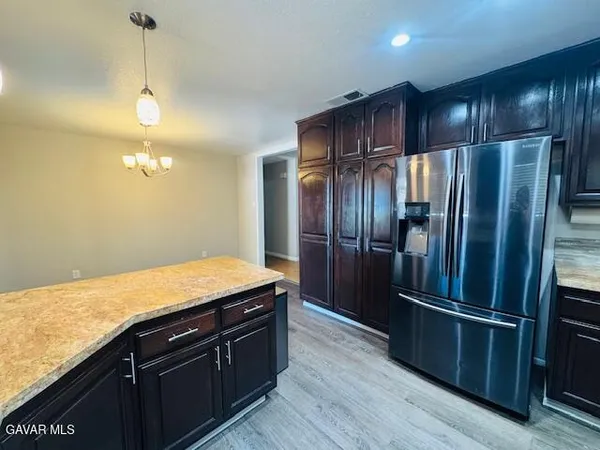 a kitchen with granite countertop stainless steel appliances and wooden cabinets