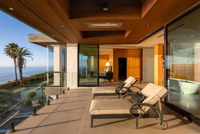 a view of a lobby with a floor to ceiling windows and potted plants