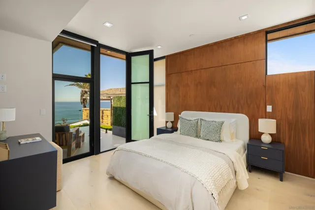 a bedroom with a large bed and a large window