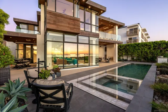 a view of a swimming pool with chairs in patio