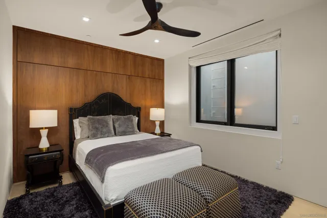 a bedroom with a bed and a lamp