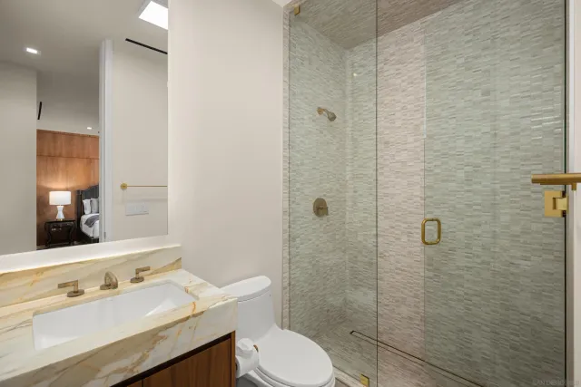 a bathroom with a sink toilet and shower