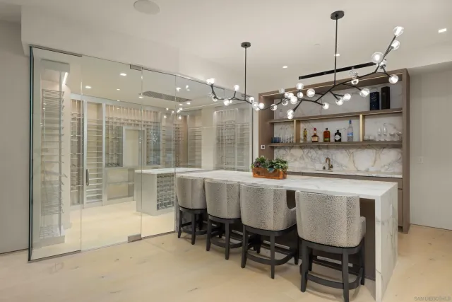 a kitchen with a dining table chairs and white cabinets