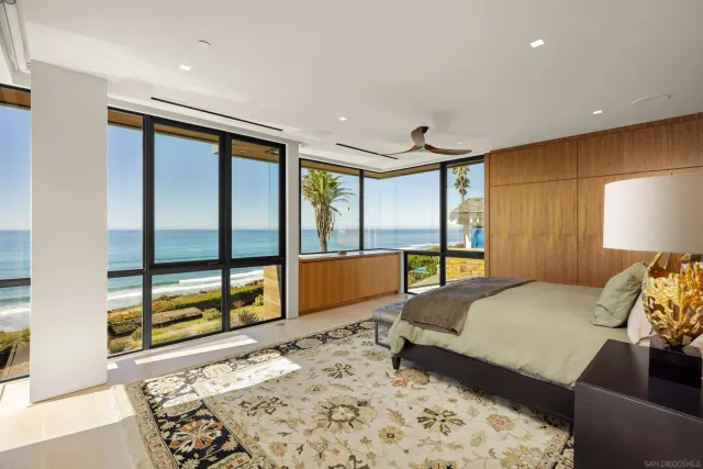 a bedroom with a large bed and a large window