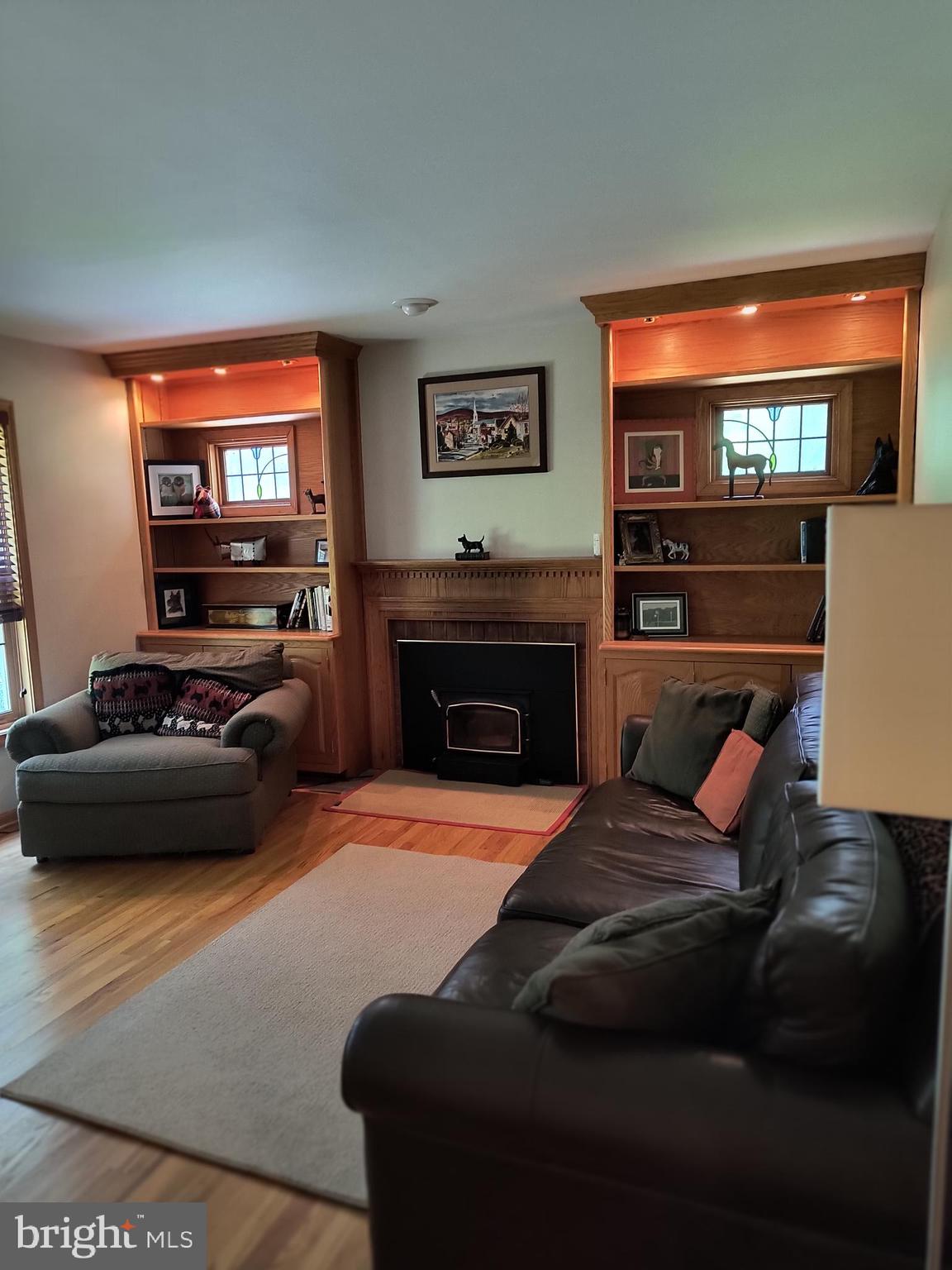 3917 Basford Road Frederick, MD 21703 - Photo 36 of 36 a living room with furniture a flat screen tv and a fireplace