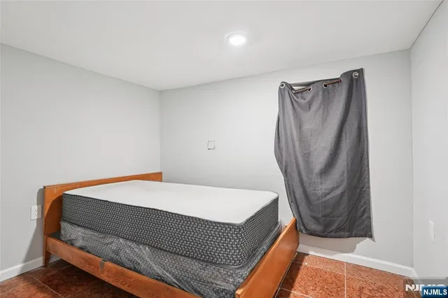 a bedroom with a bed and dresser