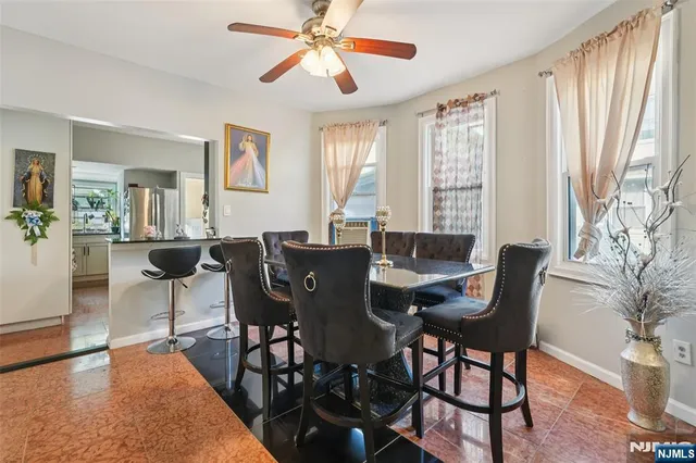 a view of a dining room with furniture and a window