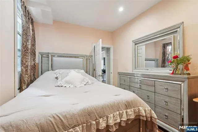 a bedroom with a bed and a large mirror