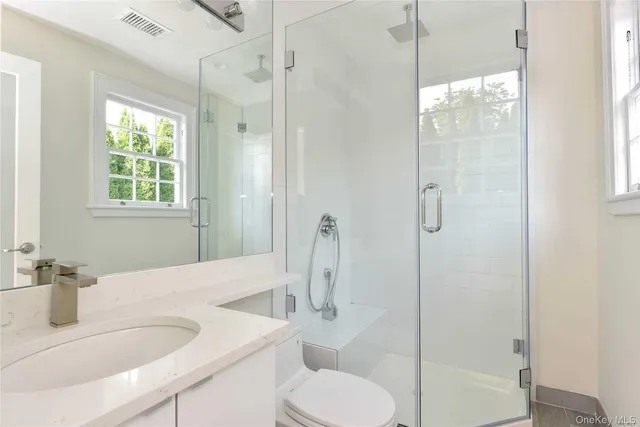 a bathroom with a sink toilet and shower