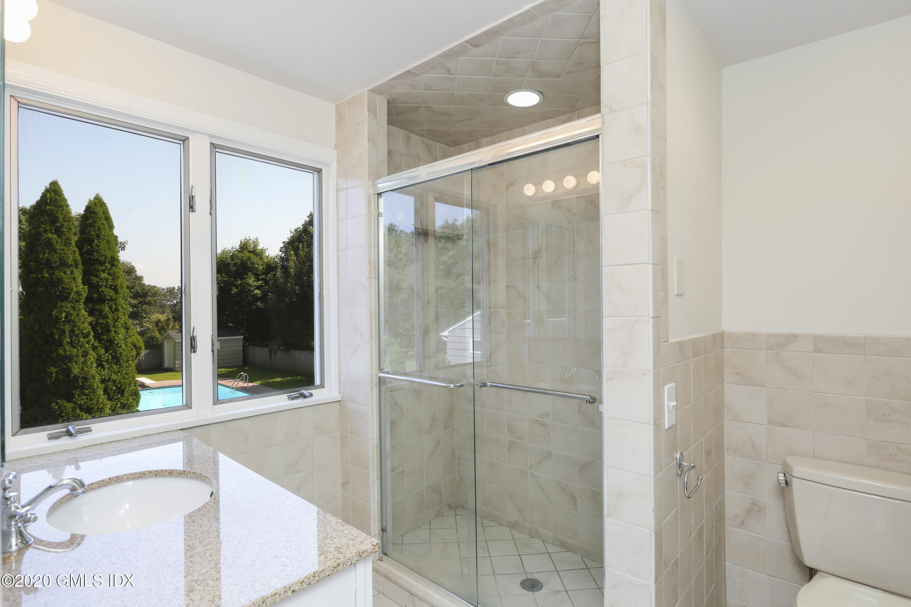 18 Norias Road Greenwich, CT 06830 - Photo 15 of 37 a bathroom with a shower and a sink
