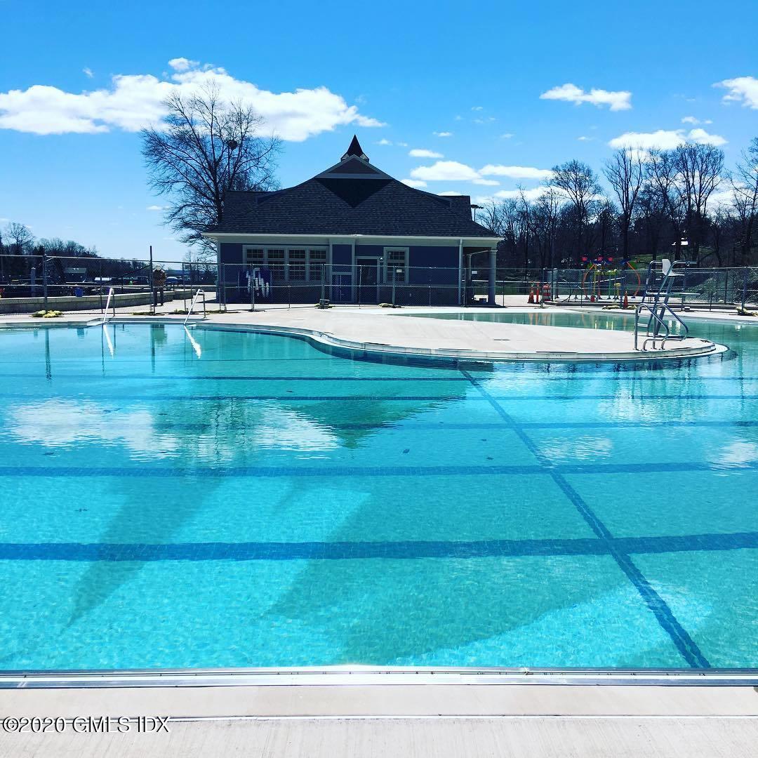 18 Norias Road Greenwich, CT 06830 - Photo 24 of 37 a swimming pool with outdoor seating and yard