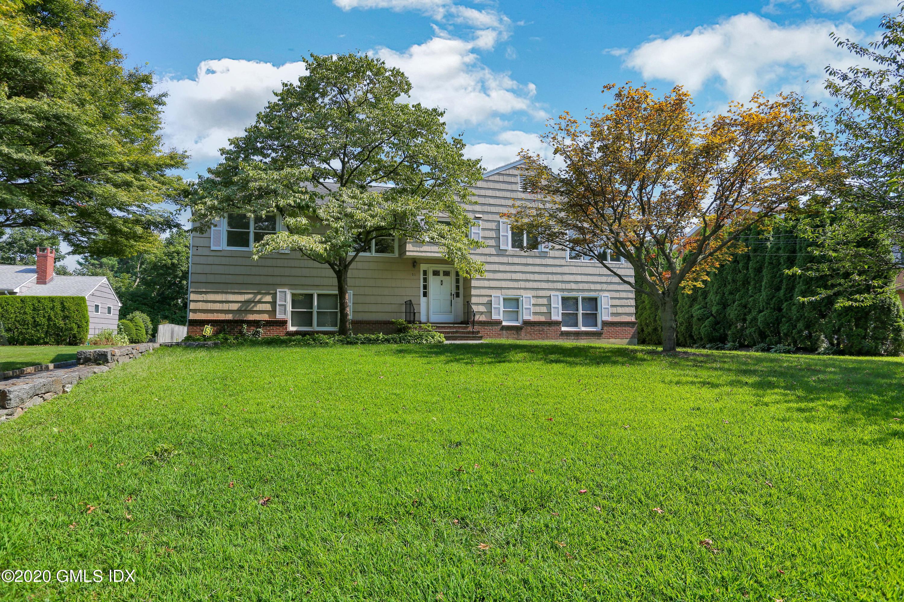 18 Norias Road Greenwich, CT 06830 - Photo 4 of 37 a front view of a house with a garden and deck