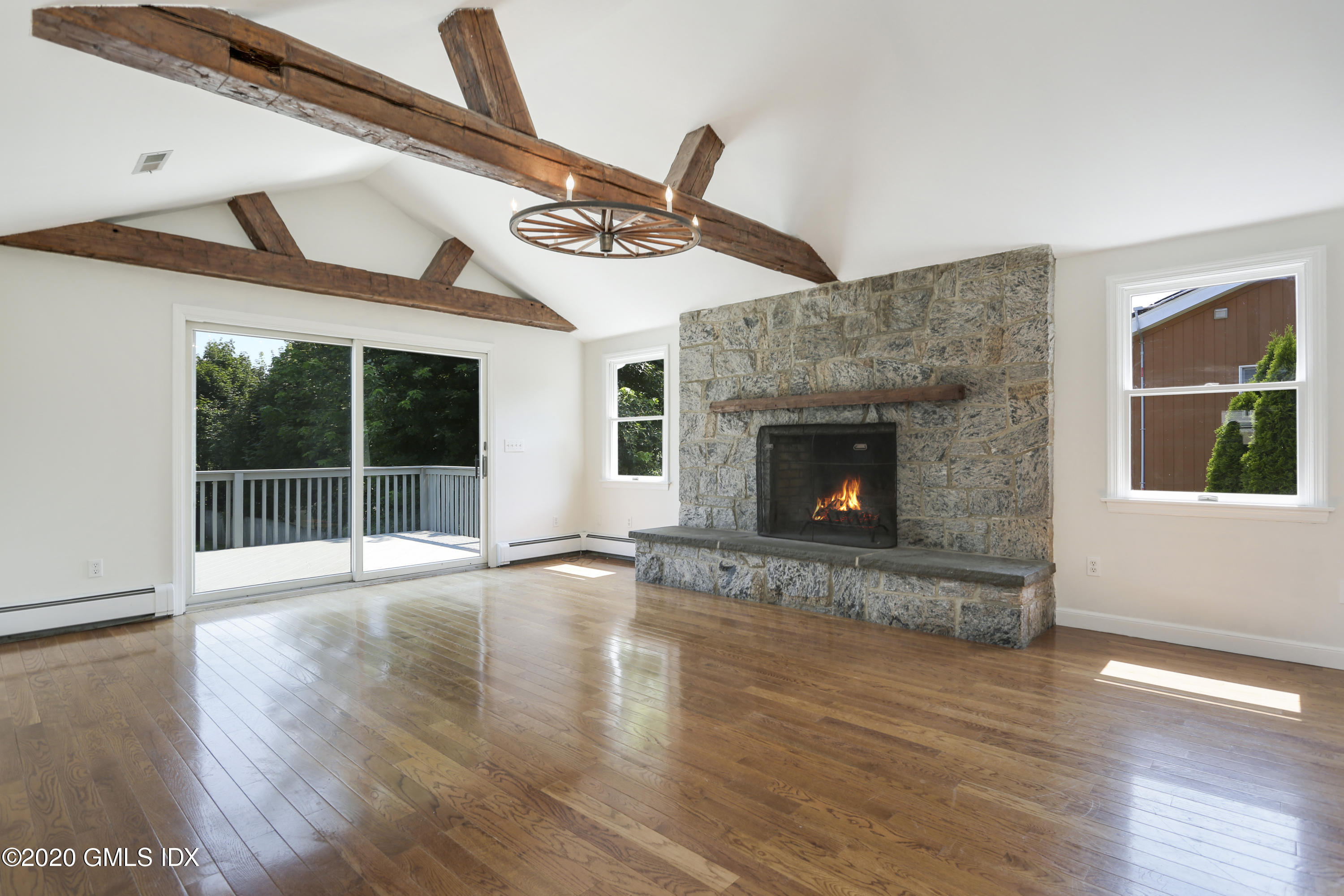 18 Norias Road Greenwich, CT 06830 - Photo 5 of 37 a view of an empty room with wooden floor fireplace and a window